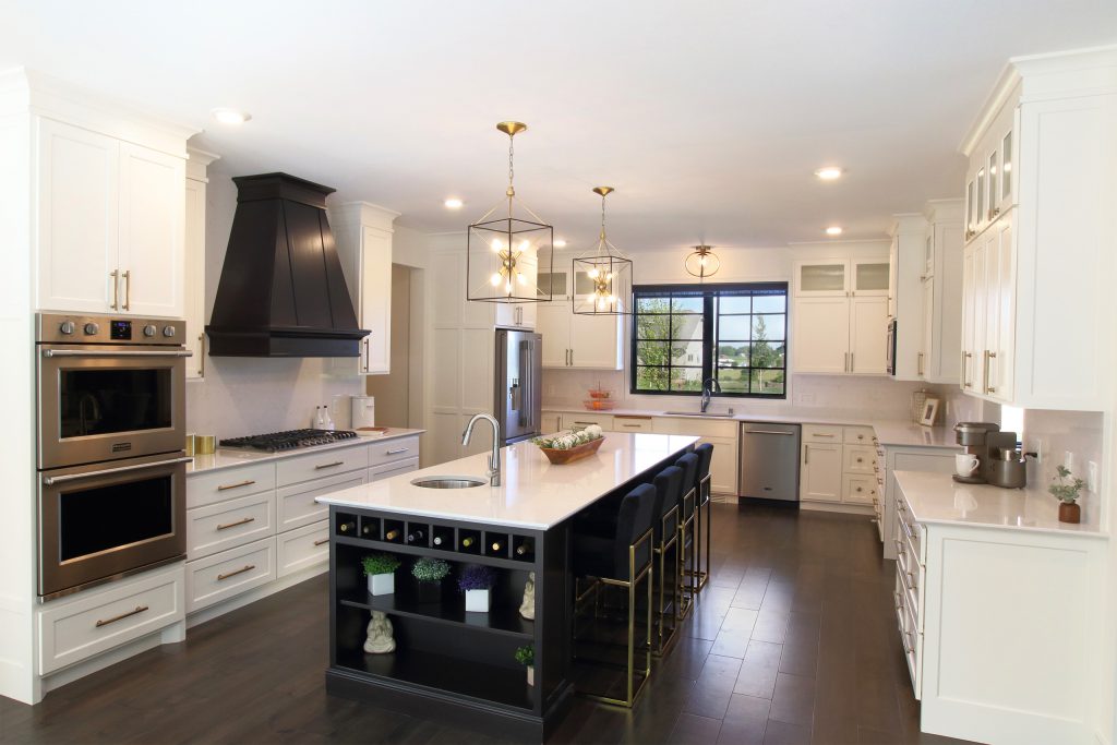 Painted kitchen cabinets with large island and painted wood hood