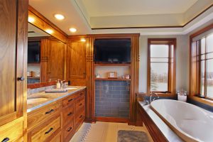 master bathroom with black walnut cabinetry and soaking tub
