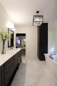 Master bathroom vanity and linen cabinet that are painted black