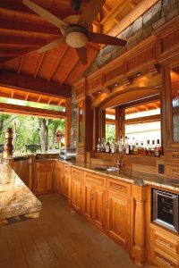 Outdoor pool bar with teak cabinets