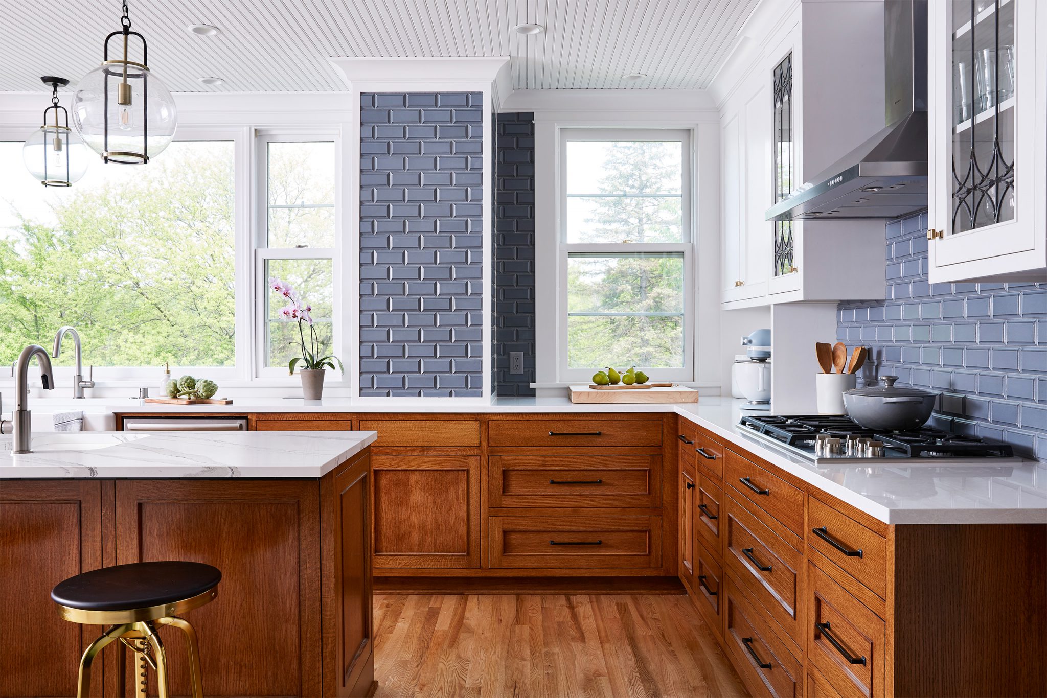 Kitchen with quartersawn red oak base cabinets and white painted uppers with glass detailing