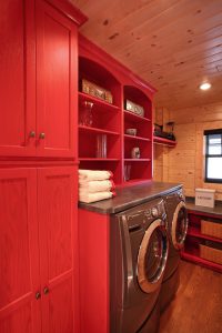 Laundry room with red painted cabinets