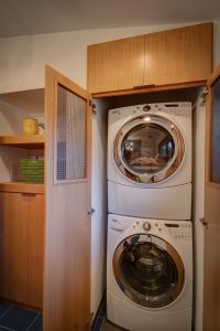 Laundry closet with quarter-sawn oak cabinets