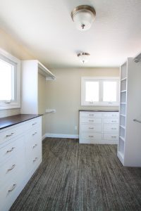 Organization Walk-in Closet with painted white cabinets