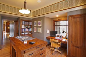 Sewing room with black walnut cabinets, built-in bookshelf, desk and island