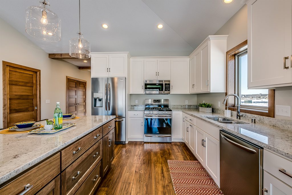 Kitchen with painted white cabinets and stained island