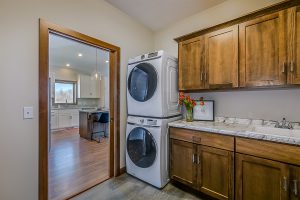 Laundry room with fir cabinets and laminate countertop