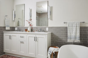 Painted white bathroom vanity with two sinks