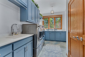 Laundry room with painted cabinets