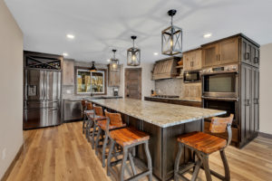 Kitchen with poplar and rustic maple cabinets and large island with granite countertop